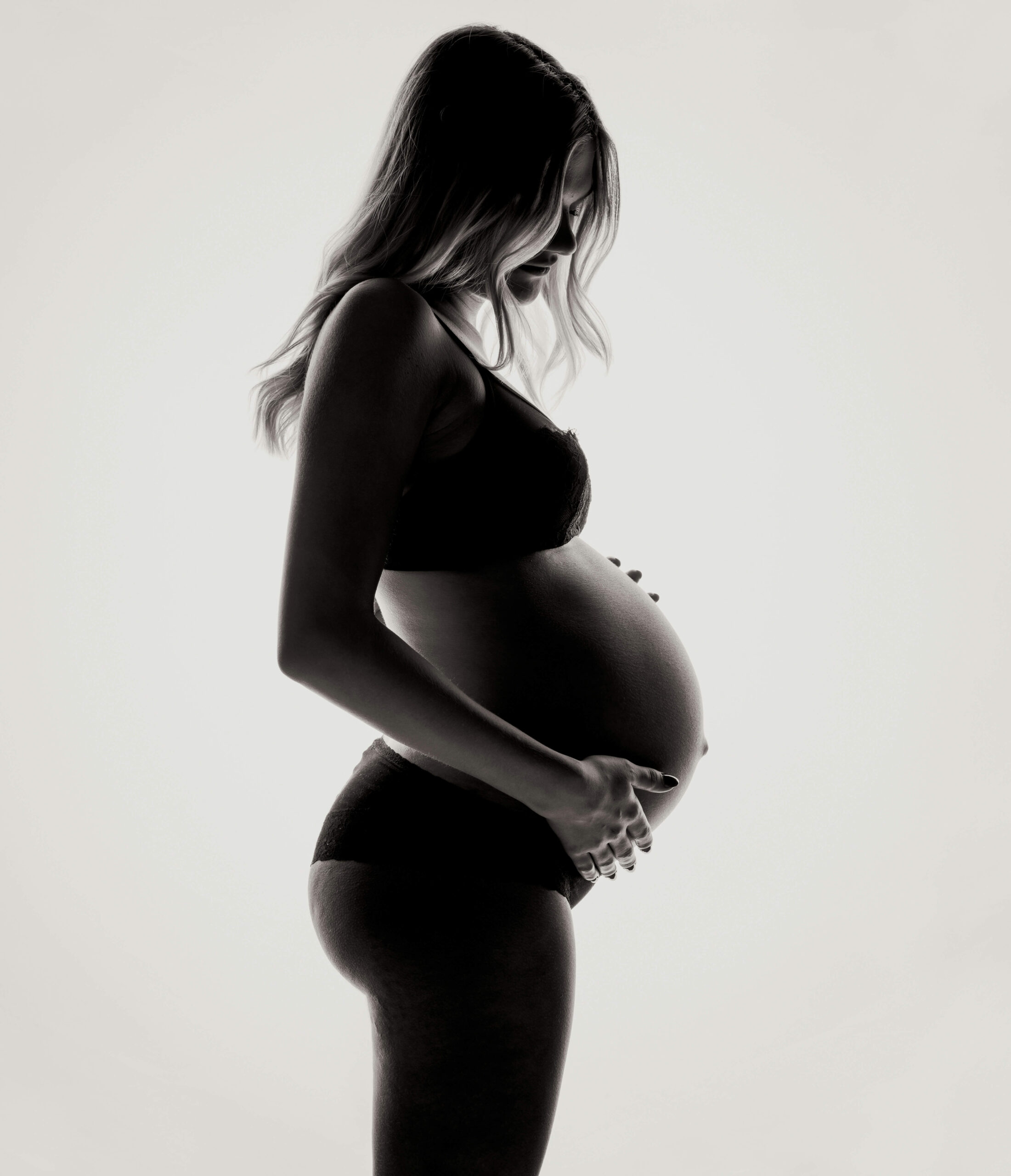 Pregnant woman reflecting on delaying motherhood while building her career